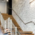 Stone wall in office building by staircase