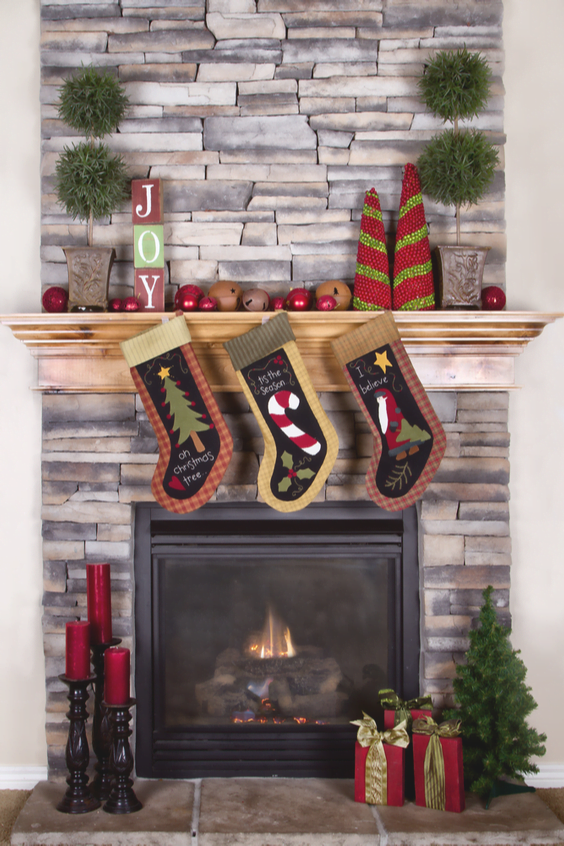 A fireplace mantle with Christmas decorations