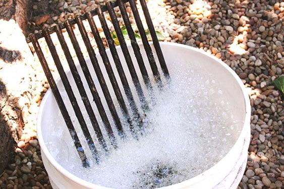 grill grate soaking in soapy water
